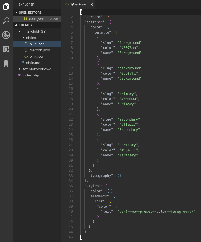 Screenshot of the Visual Studio Code UI displaying the child theme file structure of "blue.json", "maroon.json", and "pink.json" in the styles directory.