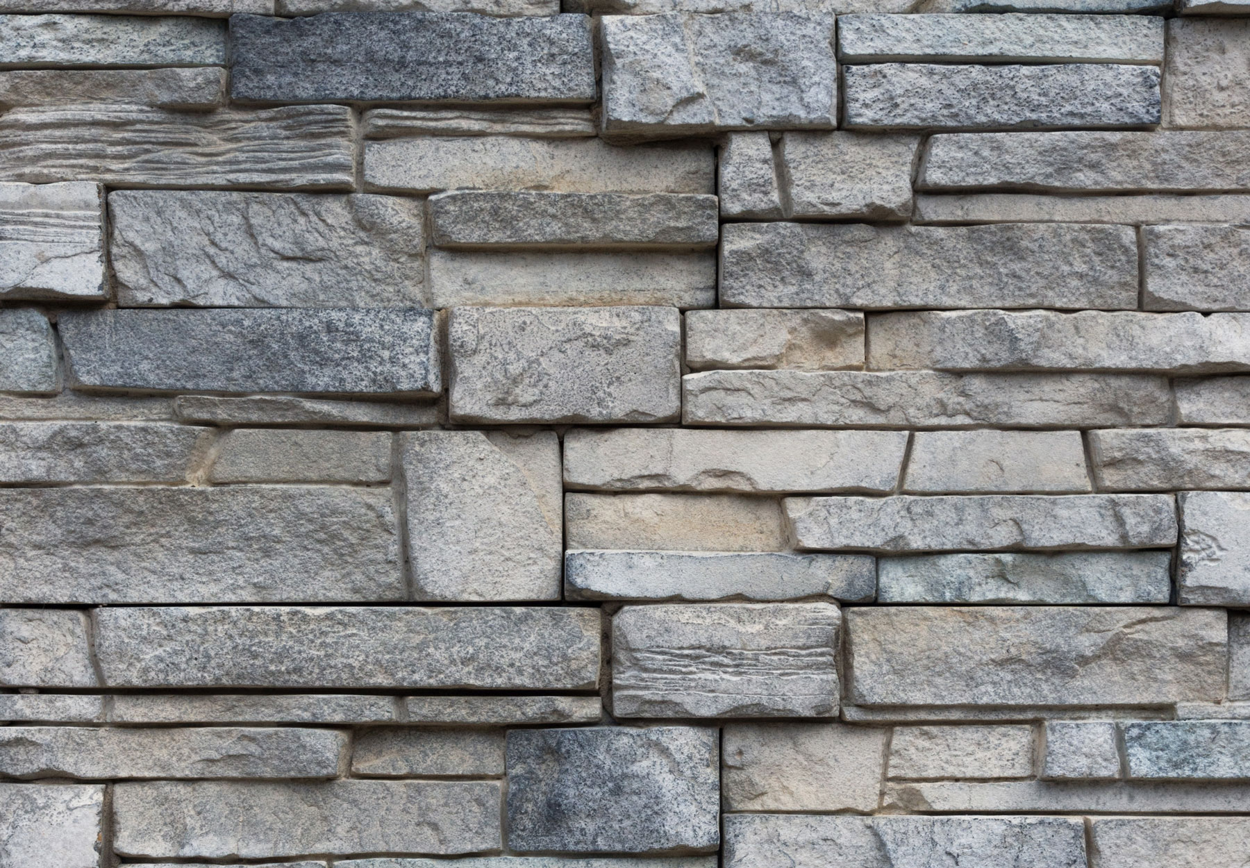 Closeup of a slate gray stone wall.